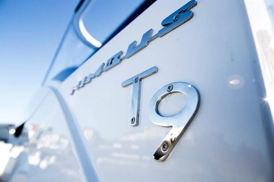 Close-up of a boat's white hull featuring the "Humber" logo and the model designation "T9" in polished metal.